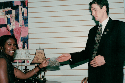 Old photo of Jeff Jones handing Yvonne Westbrook a baggie filled with cannabis.