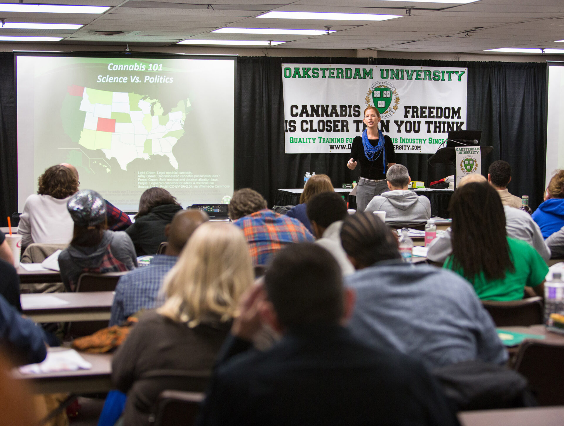 dale colorado Photo taken at a distance of Dale Sky Jones standing in front of rows of students. She is in front of an Oaksterdam University banner that reads "cannabis freedom is closer than you think"