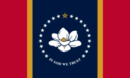 The Mississippi flag, a magnolia flower is in a navy blue panel in the center surrounded by stars and the words "In God We Trust." On either side of the blue panel are thin yellow panels and then dark red panels to the edge of the flag.