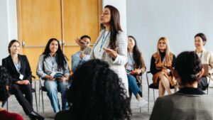Woman of color facilitating a group interaction.