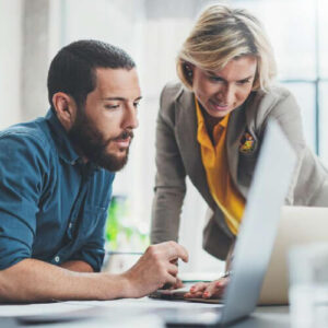 Coworkers team at work. Group of young business people in trendy casual wear working together in creative office.